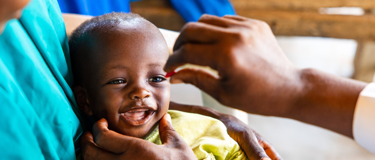 Hajara Isah's child receiving vitamin A supplement.