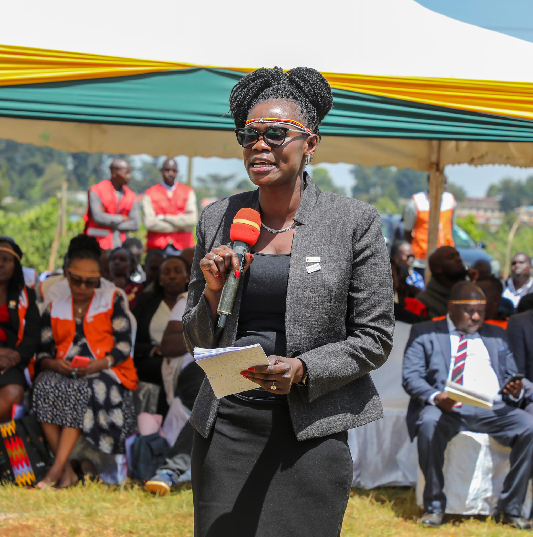 A woman gives a speech to a crowd