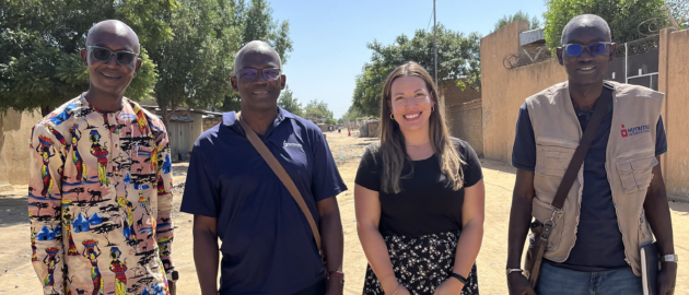 Nutrition International staff outside in the capital of Chad, smiling to the camera.