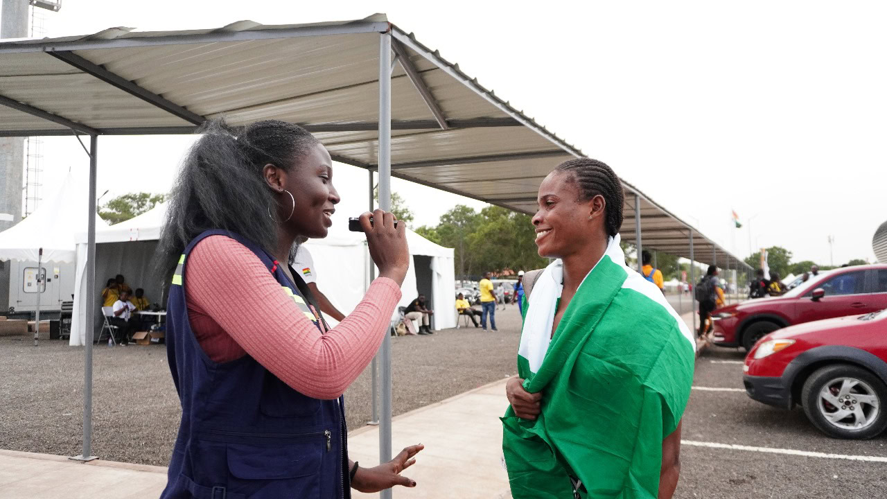 A female journalist interviewing an athlete.
