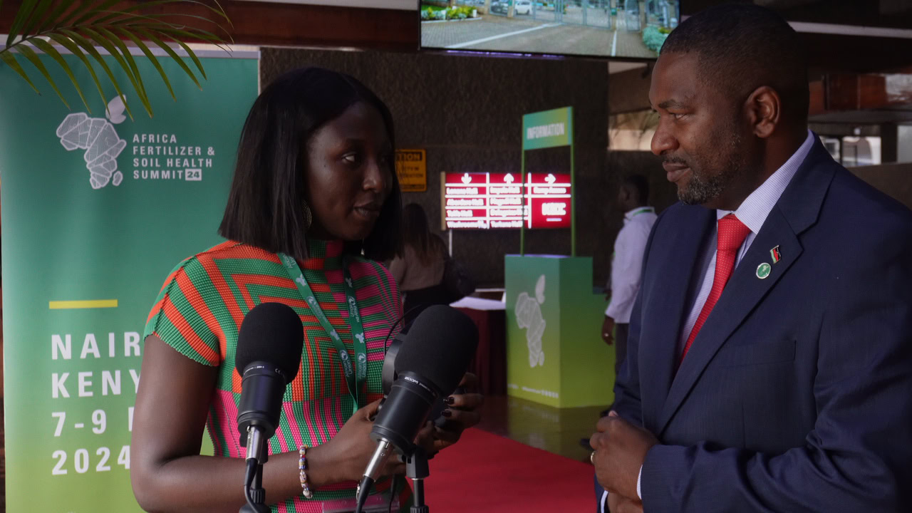 A reporter is interviewing a man in a suit outside.