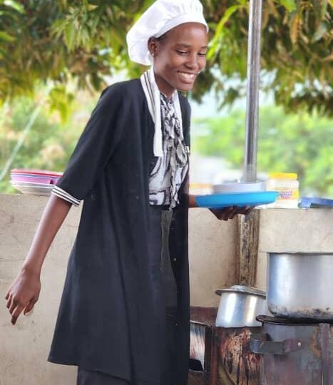 A woman standing outside serving food
