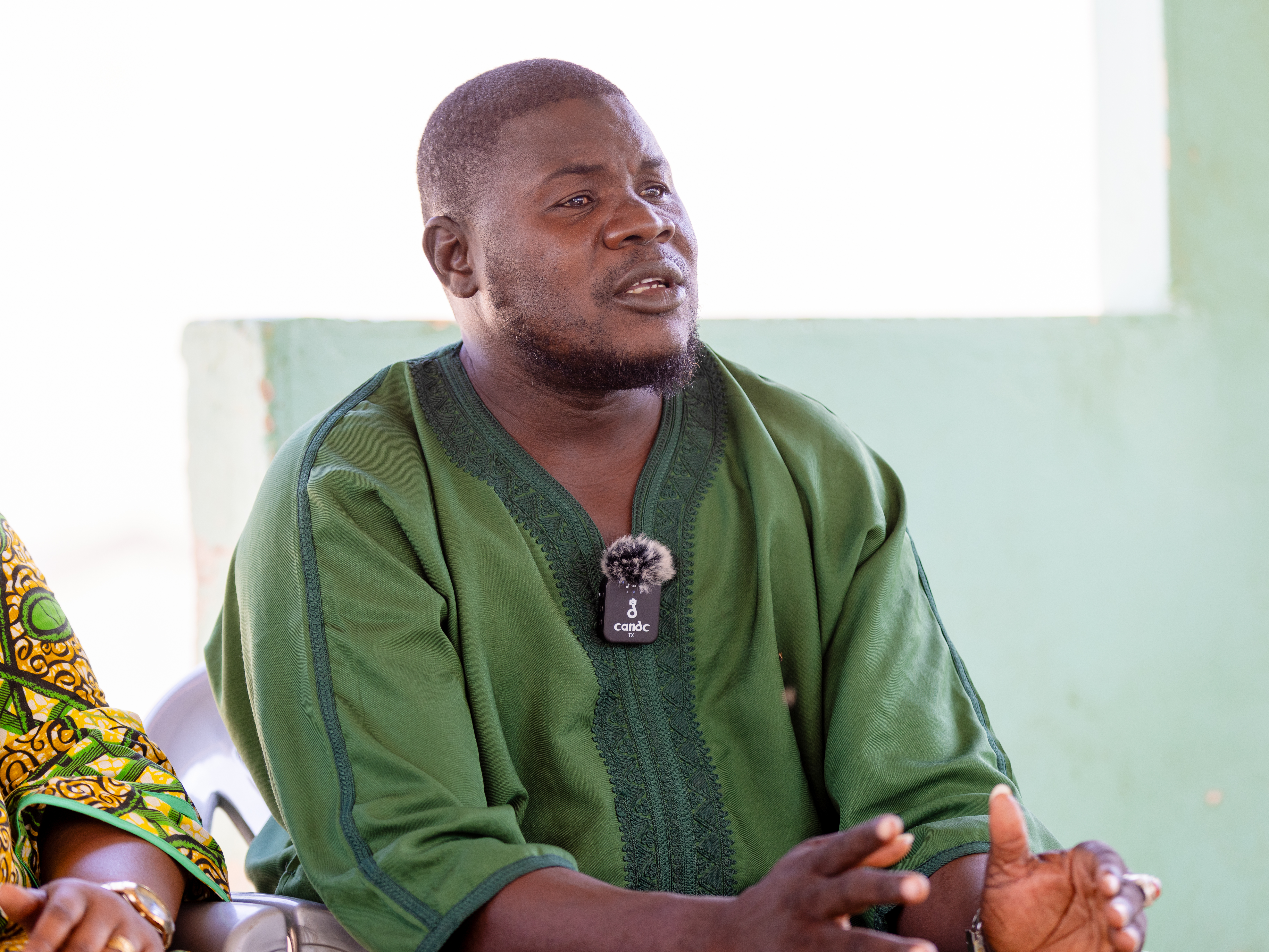 A man speaking and gestures with his hands.