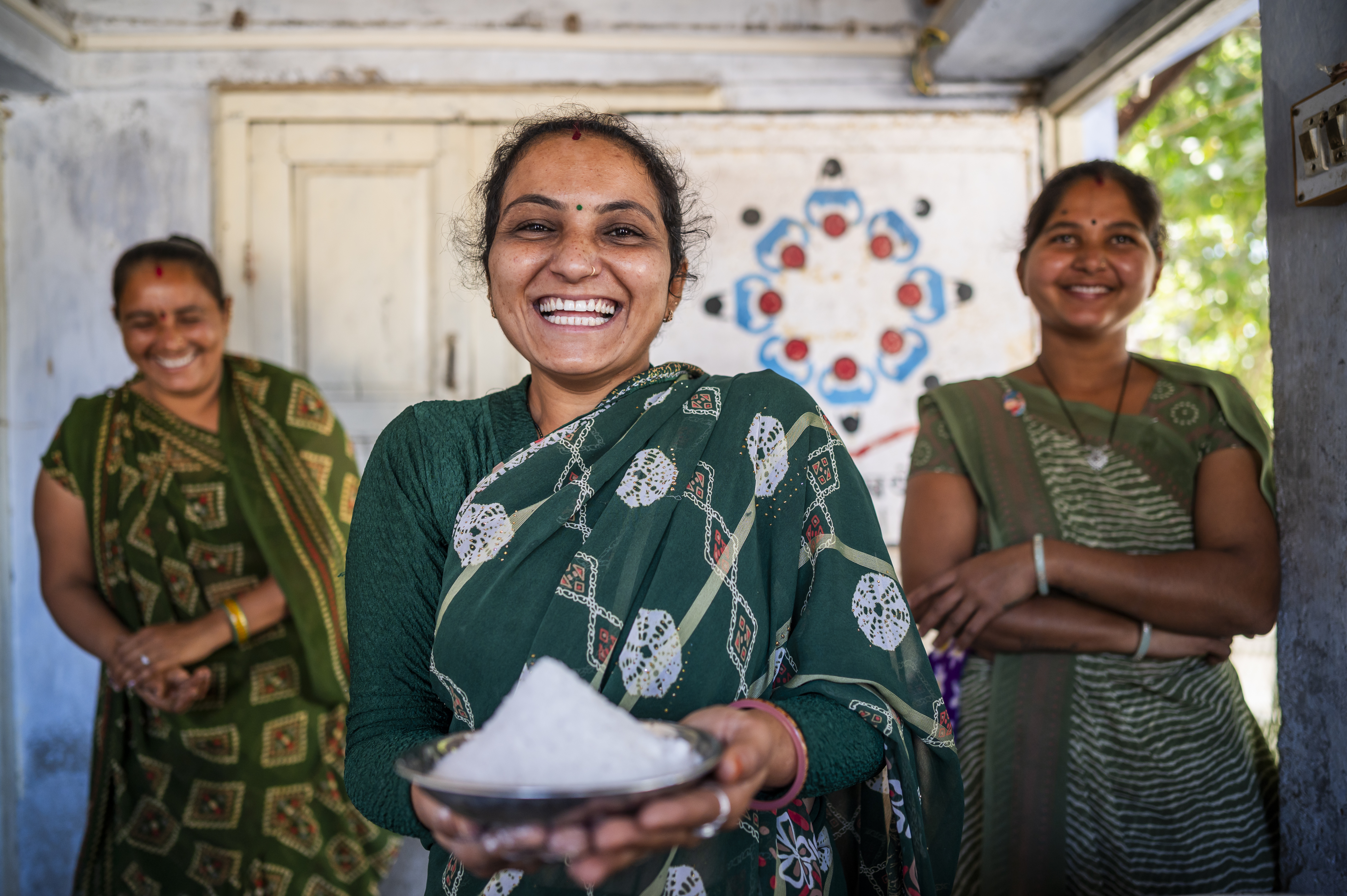 A woman smiles and displays iodized salt.